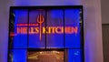 Gordon RamasyÃ¢â¬â¢s HellÃ¢â¬â¢s Kitchen restaurant with red and blue lights at night in Las Vegas Nevada